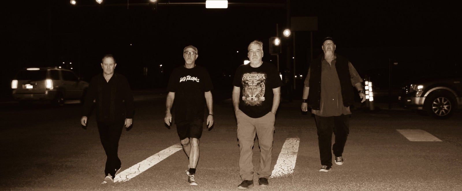 The four members of Zero Tolerance walking together at night