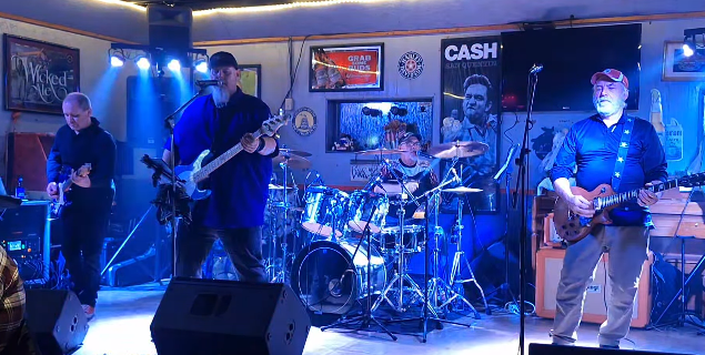 Zero Tolerance performing live under blue stage lights